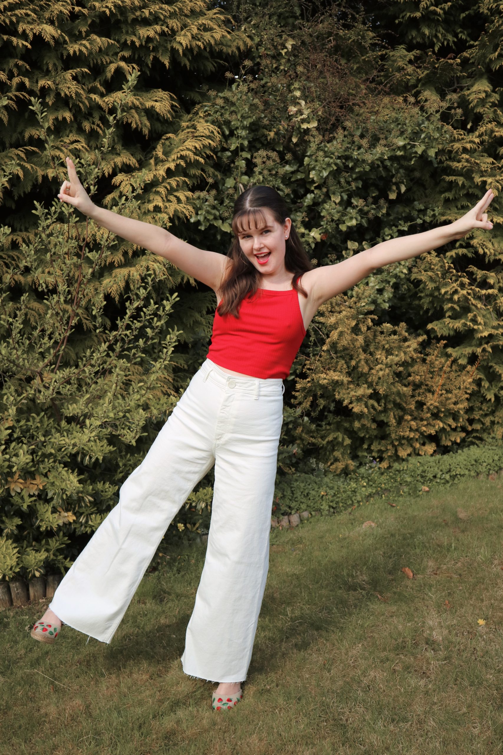 Red top, white jeans and strawberry espadrilles outfit